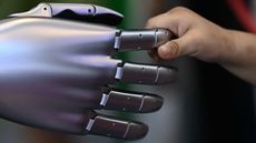 Robot hand held by human hand