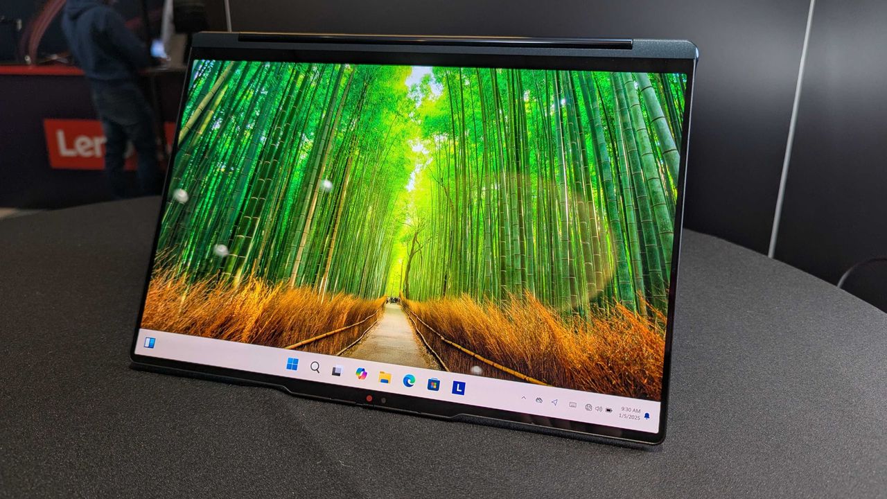The Lenovo Yoga 9i 2-in-1 14 (Gen 10) Aura Edition on a desk in the "tent" position.