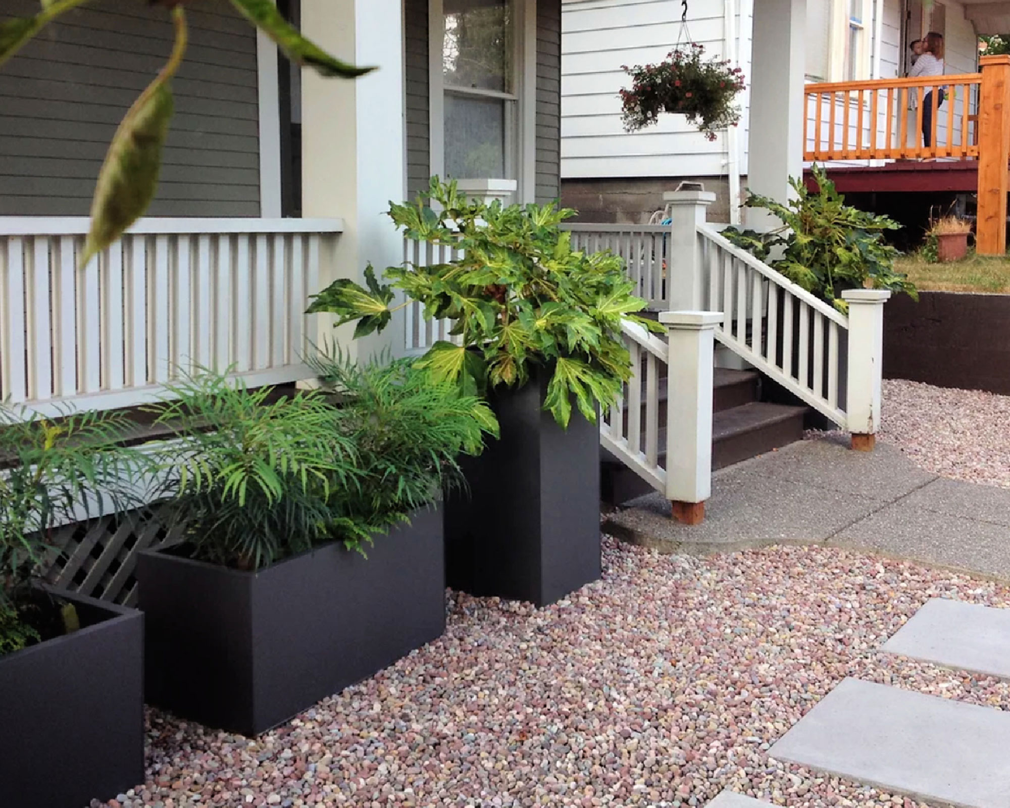 trio of large planters near a front porch