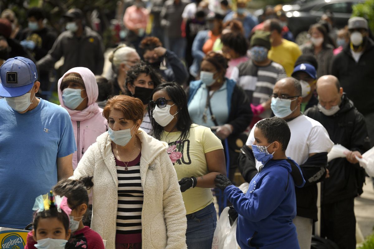 People waiting in line and wearing face masks in Reading, PA on April 25, 2020.