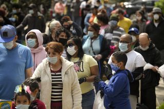 People waiting in line and wearing face masks in Reading, PA on April 25, 2020.