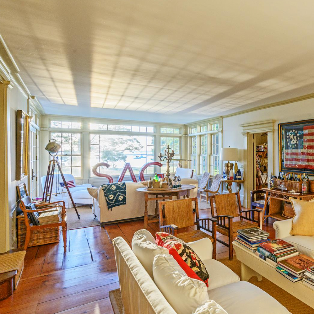 living room with white windows and chairs