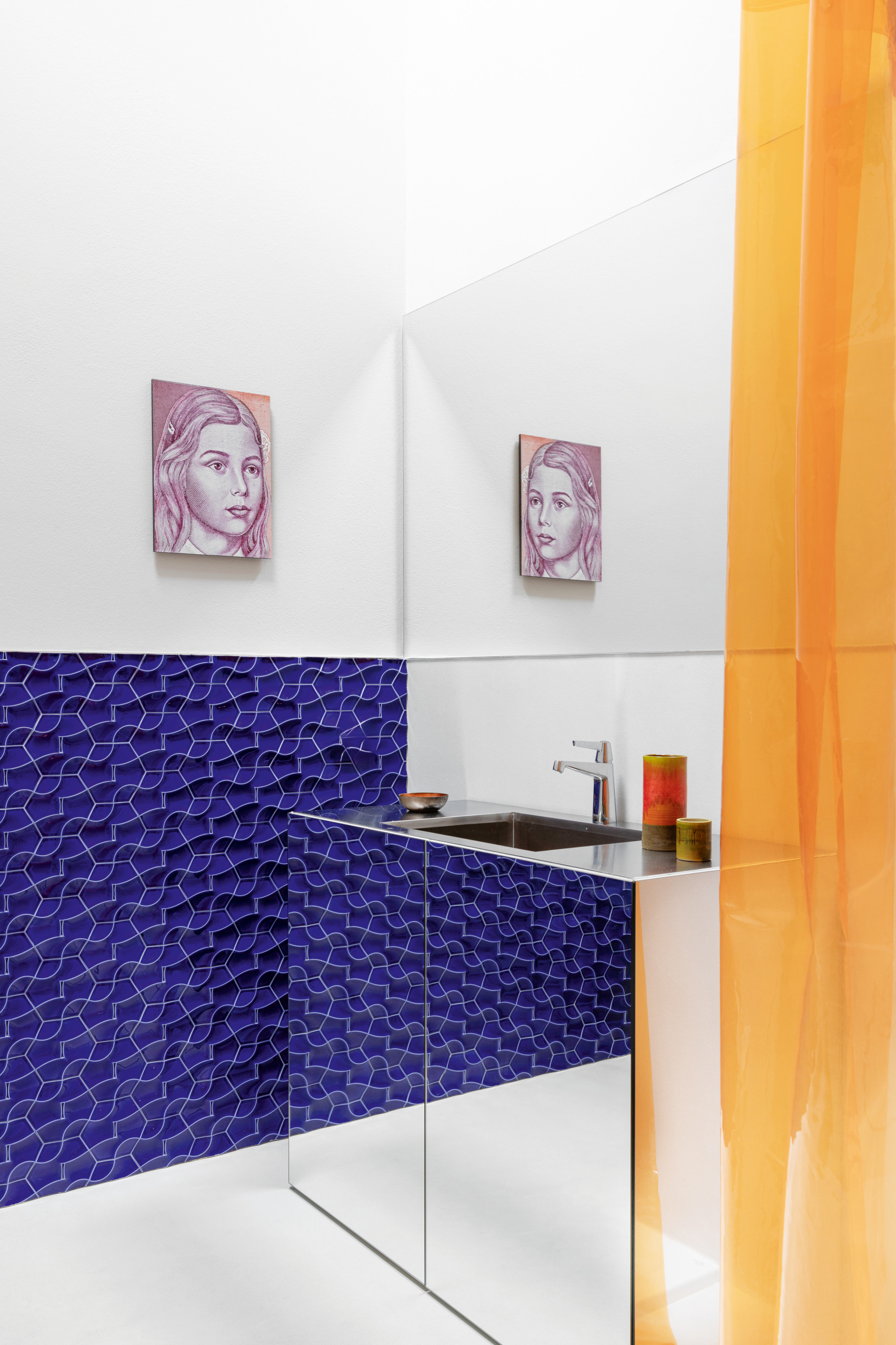 Cloakroom with mirrored vanity, violet geometric tiles, painting of girl's face