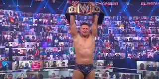 The Miz raising the WWE Championship belt.