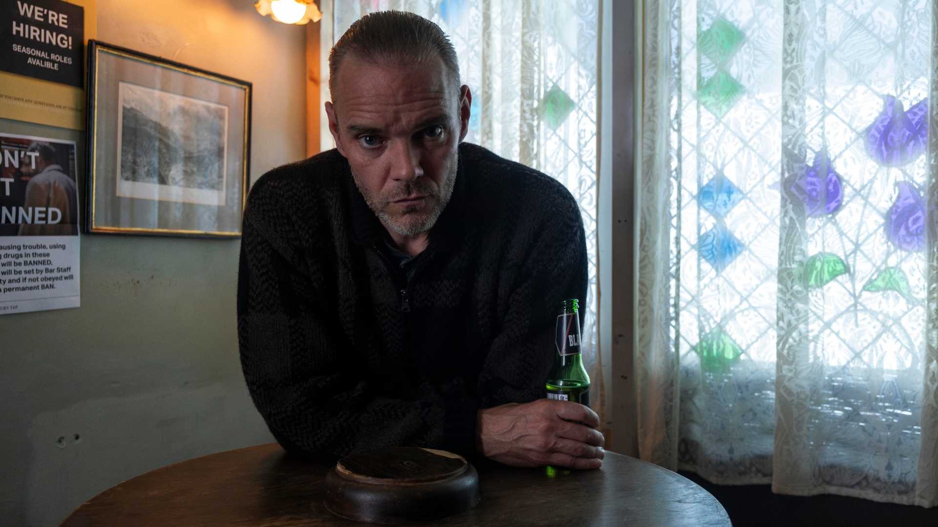 Hulk stares leaning over a table in the pub in Code of Silence