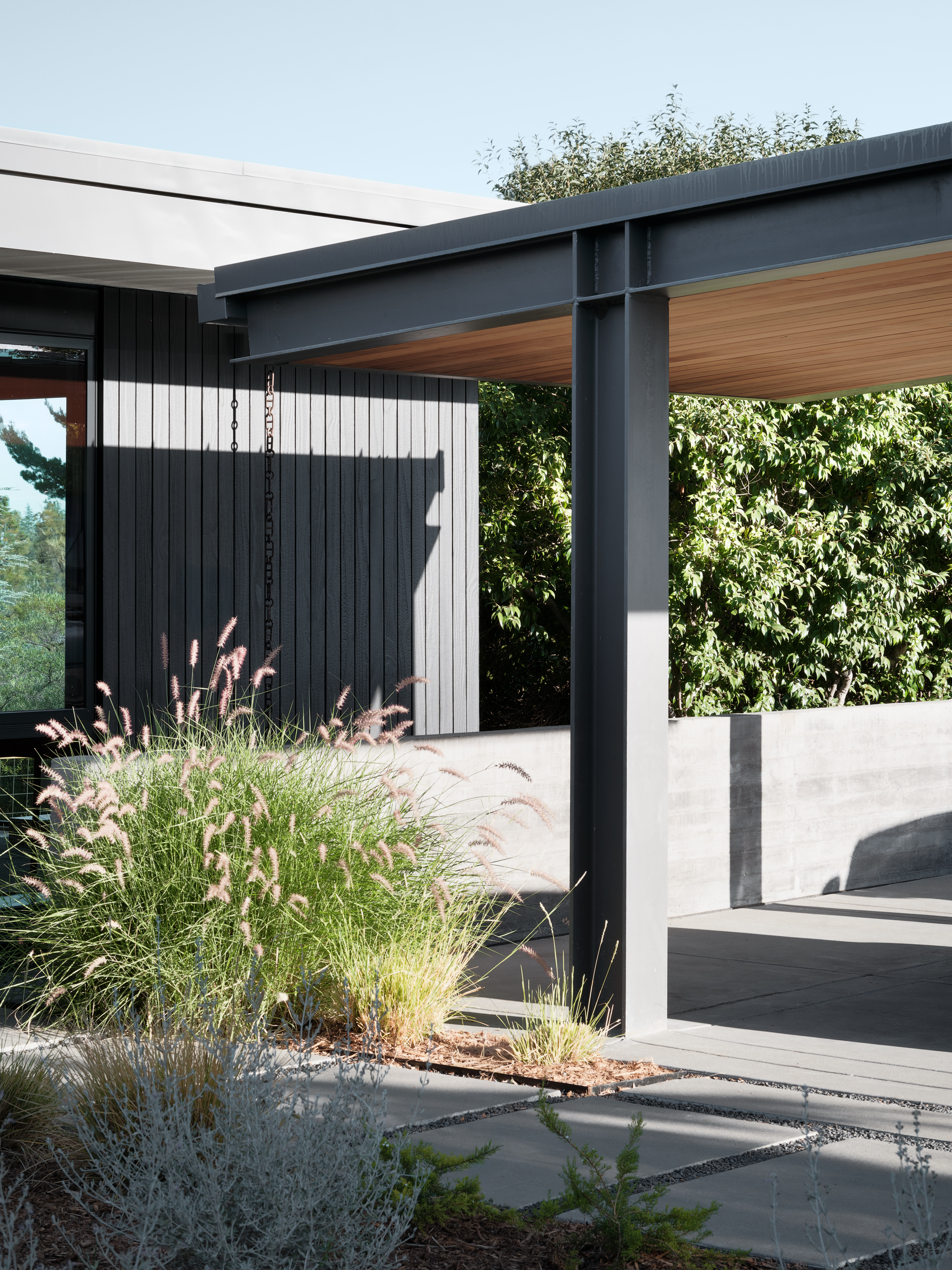 Hilltop Residence by Michael Hennessey Architecture, a modernist inspired home, low lying and linear with timber ceilings and black accents