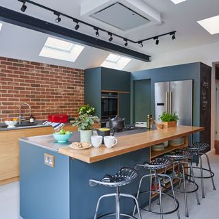 kitchen with brick wall refrigerator roof window and bar stool