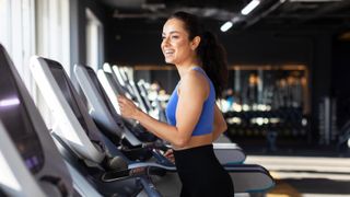 a woman walking on a treadmill