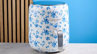 the Laura Ashley Air Fryer in blue and white floral print, showing the air fryer basket and black touchscreen on the top