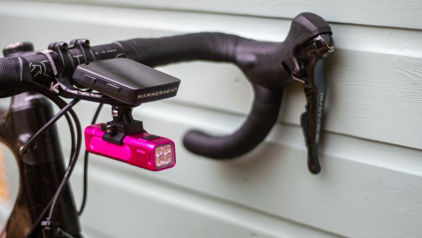 A pink Knog Blinder light mounted to a bike computer