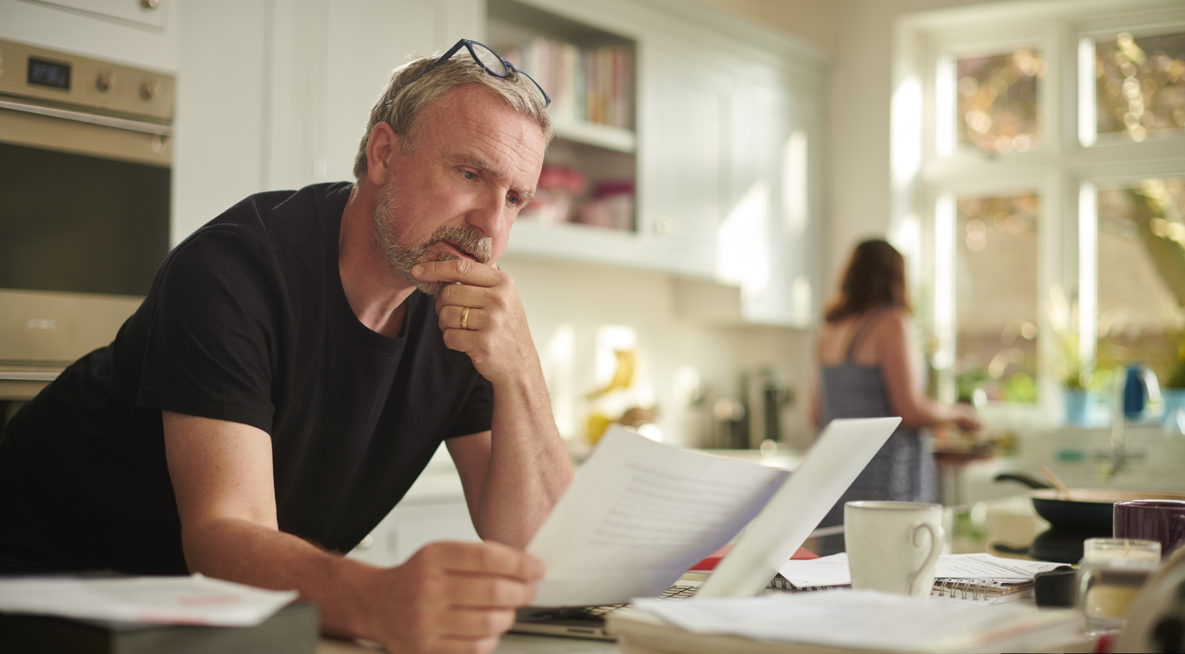 Man looking over his phone bill