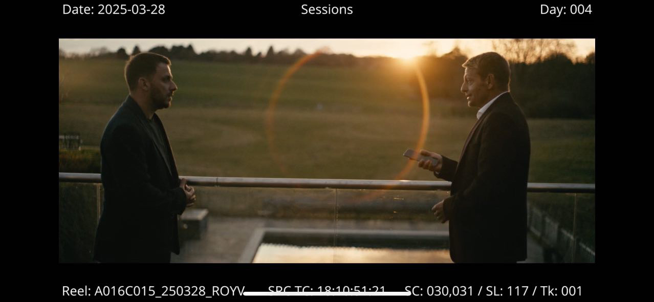Image from a video monitor showing two people talking
