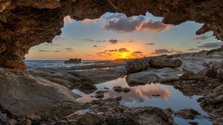 cave and beach at sunset in cyprus