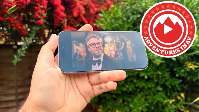 A hand holding an iPhone with a shot of "The Studio" on screen, a red icon reading "Adventures in AV" is to its right