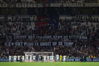 Olympique Lyonnais players look on as the fans display banners bearing the message; "If There are any leaders in this dressing room they no longer have a right to be silent" following the final whistle of the Ligue 1 Uber Eats match between Olympique Lyonnais and Paris Saint-Germain at Groupama Stadium on September 03, 2023 in Lyon, France.