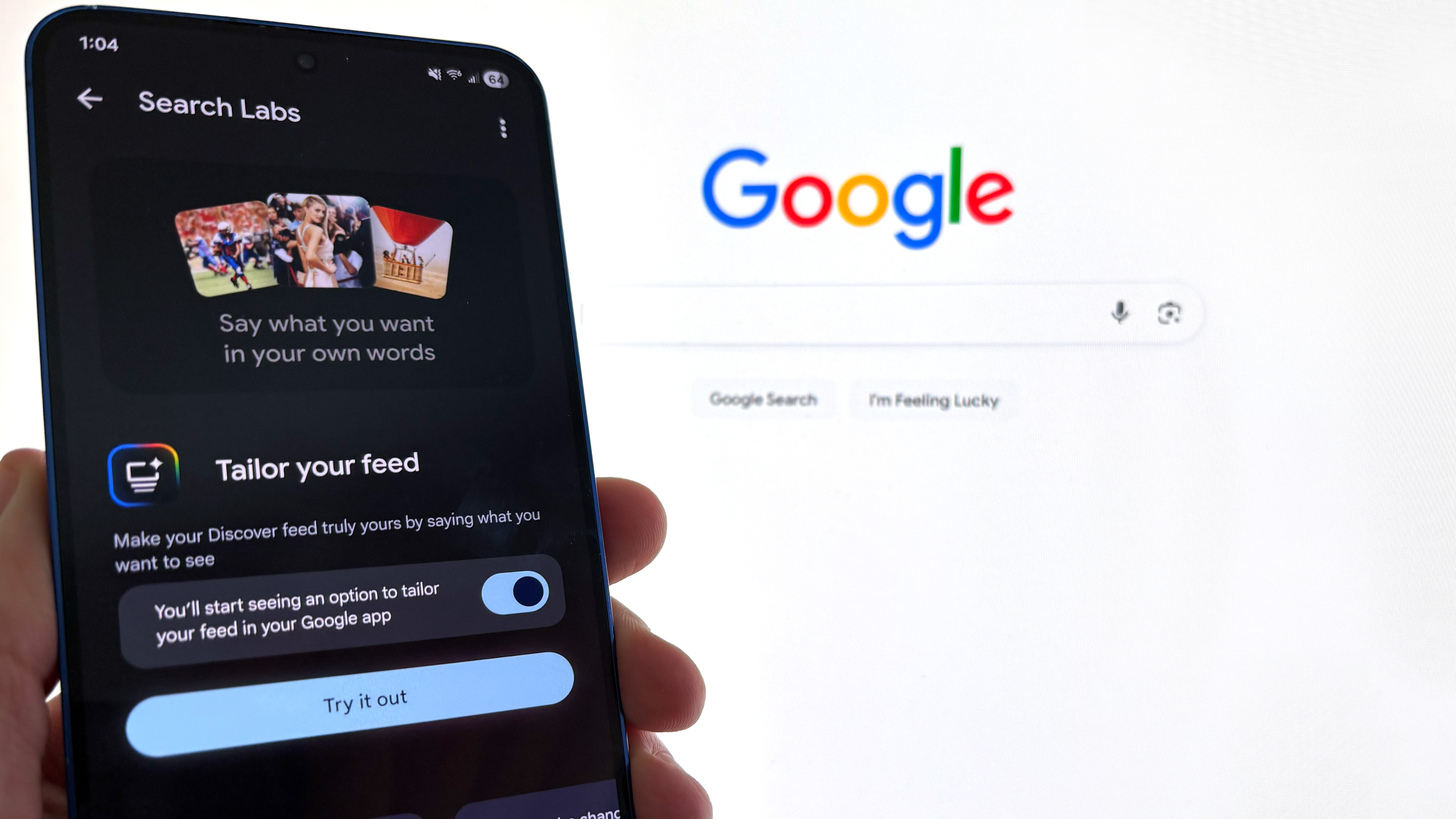A phone with Google Discover's AI Tailor your Search option in front of the Google logo