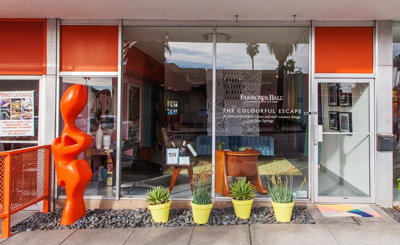 Exterior of the Farrow &amp; Ball premises featuring a tall orange sculpture