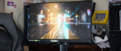 A Lenovo G25-10 gaming monitor showing a rainy street