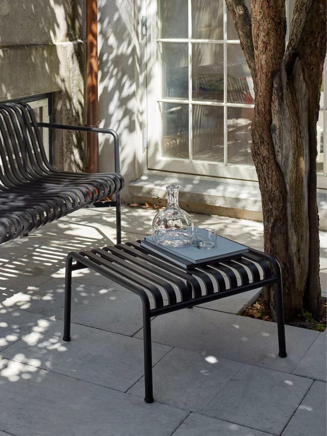 A black outdoor ottoman from HAY