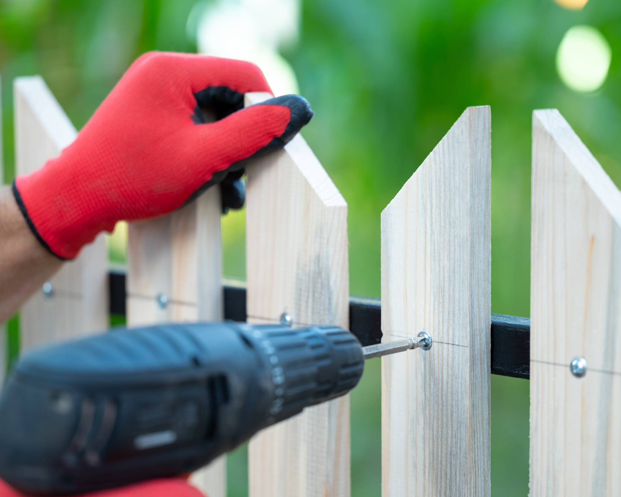 Man building fence in yard