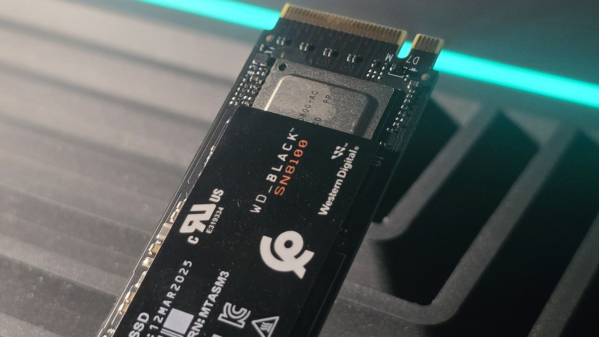 A WD Black SN8100 solid-state drive on a desk and ready to be installed.