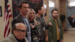 From left to right: Danny DeVito looking into camera, Rob McElhenney looking to his right, Kaitlin Olson smiling into the camera, Glenn Howerton looking far to the right and Charlie Day looking nervous into the camera.