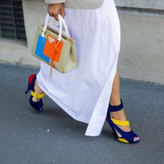 a woman walking in a colourful outfit - popsicle nails