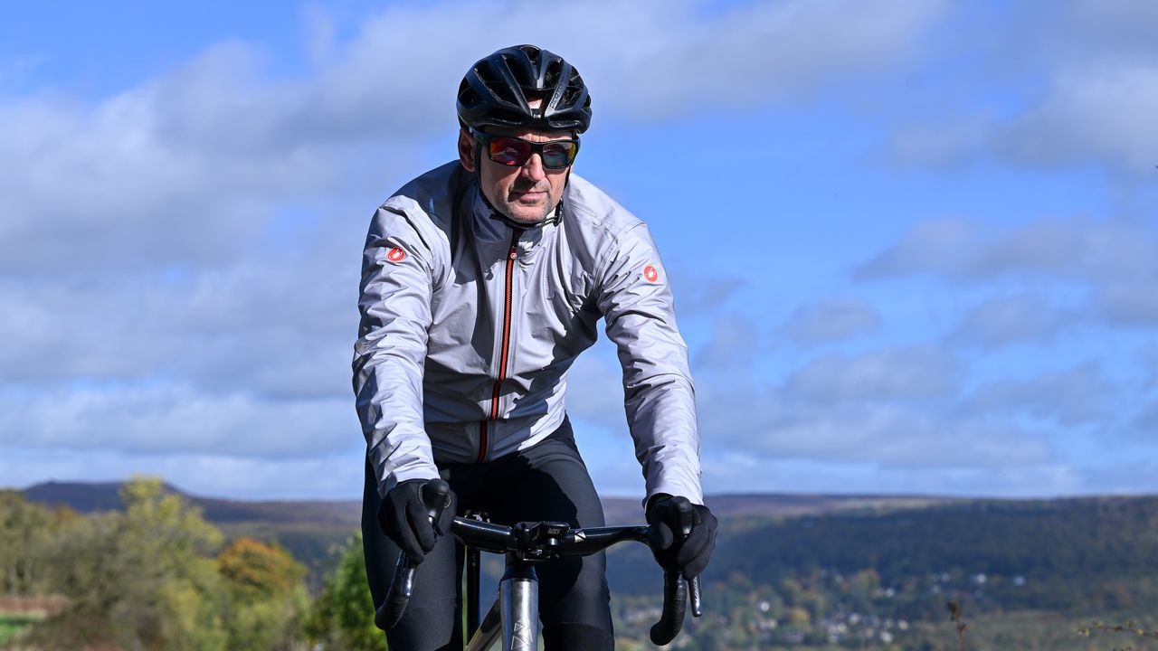 Rider wearing a Castelli Tempesta Lite waterproof jacket riding towards the camera