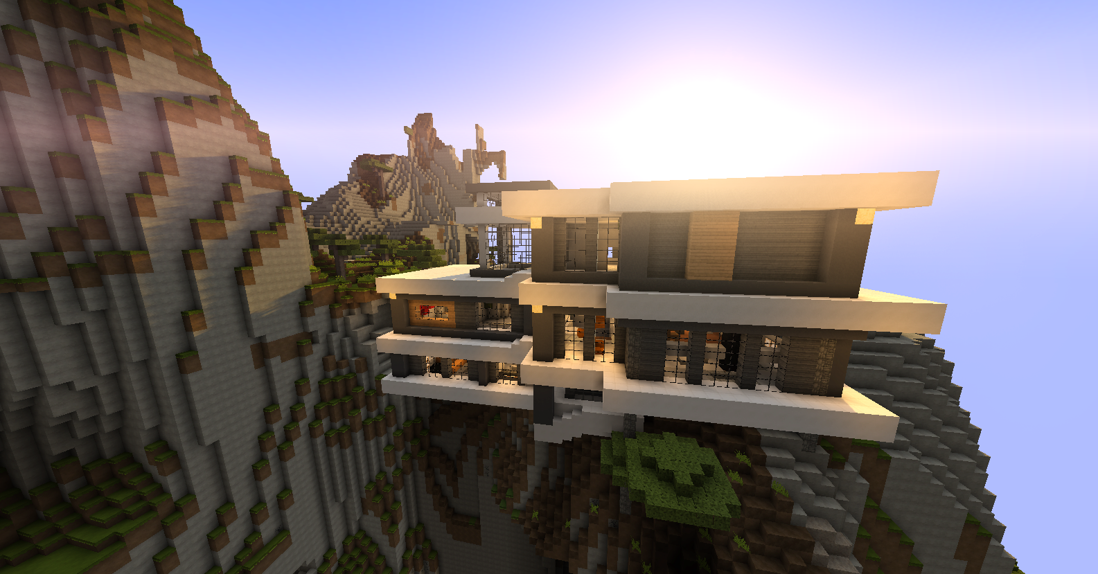 A Modern Minecraft mansion with a flat roof, resting on the side of a cliff.