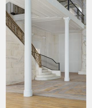 White pillars and grand staircase inside Jack Shainman gallery