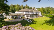 The white exterior of Dunkeld House Hotel on a summer day