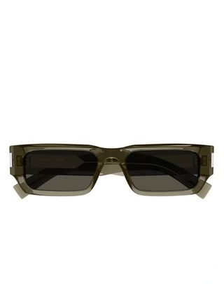 A pair of square sunglasses in olive stand against a white background.