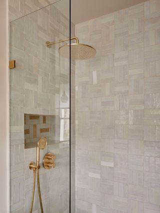 Textured bathroom walls with a mix of terracotta tile and zellige tiling