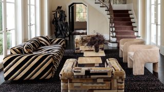 a neutral living room with beige, patterned furniture, including a striped beige and black couch