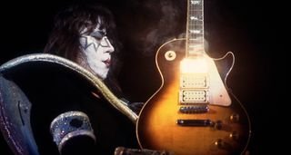 Ace Frehley holds a smoking hot Les Paul, with heat and light emitting from that neck humbucker position