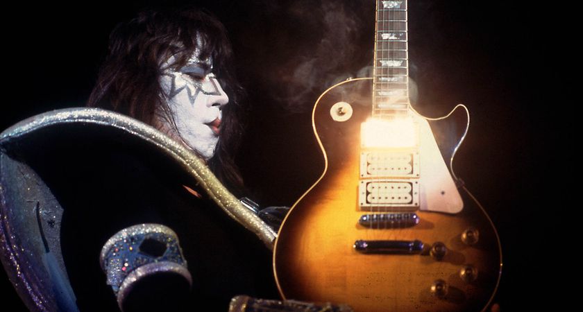 Ace Frehley holds a smoking hot Les Paul, with heat and light emitting from that neck humbucker position