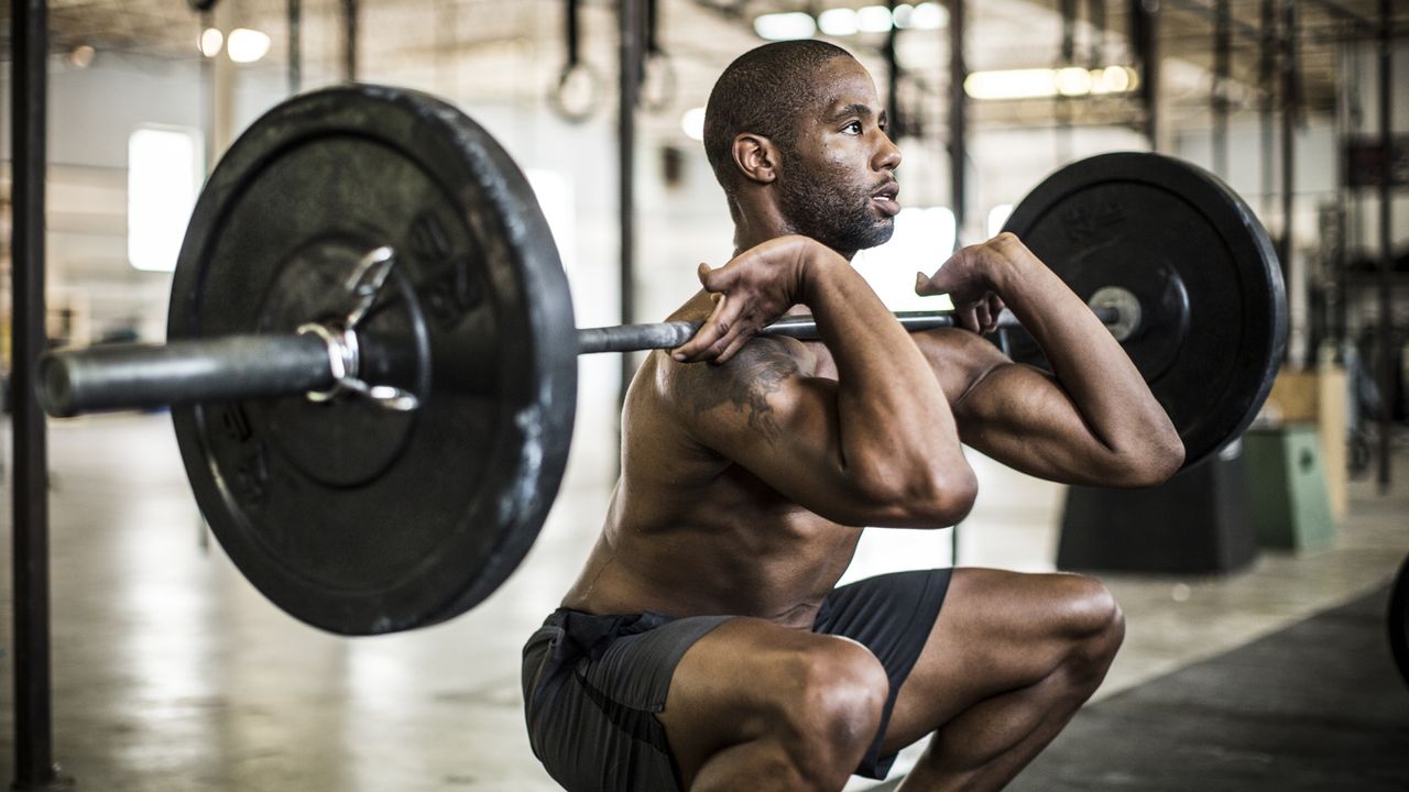 Shot of a man doing front squats in the gym 