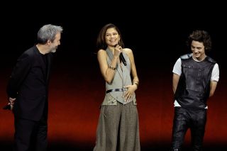 Denis Villeneuve, Zendaya laughing and Timothee Chalamet on stage talking about Dune: Part Two at CinemaCon