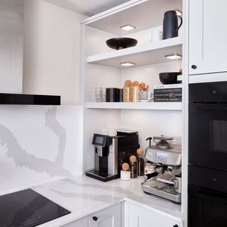 Light grey modern shaker kitchen with coffee station.