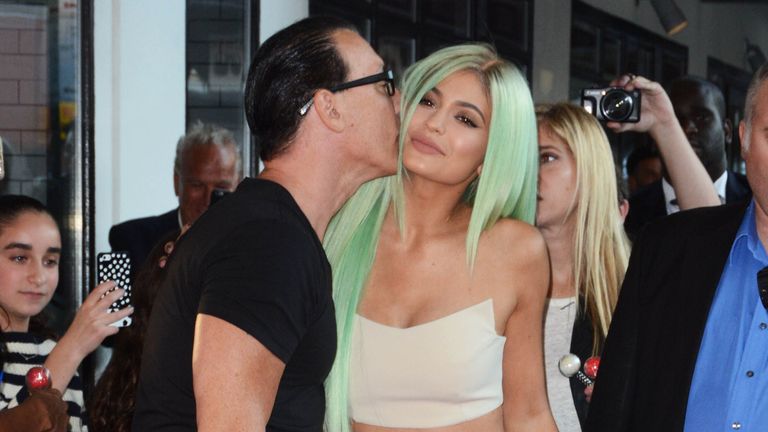 Kylie Jenner being kissed on the cheek by a man