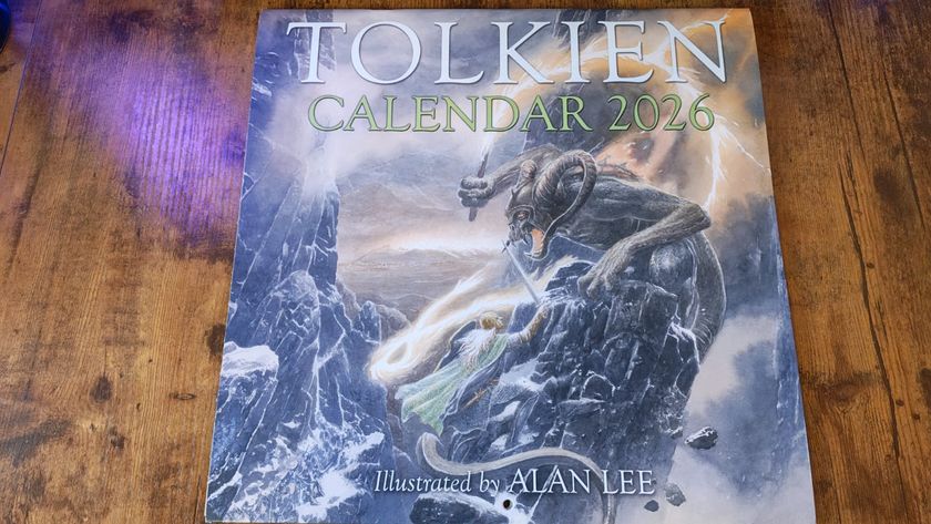 The cover of the Official Tolkien Calendar 2026 on a wooden desk