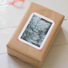 Wrapped present in brown wrapping paper with decorative card on top