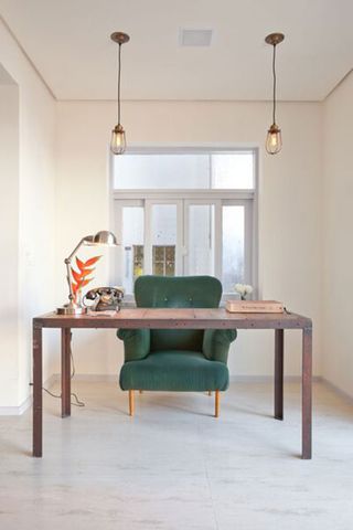 Club house room with green sofa chair and table lamp