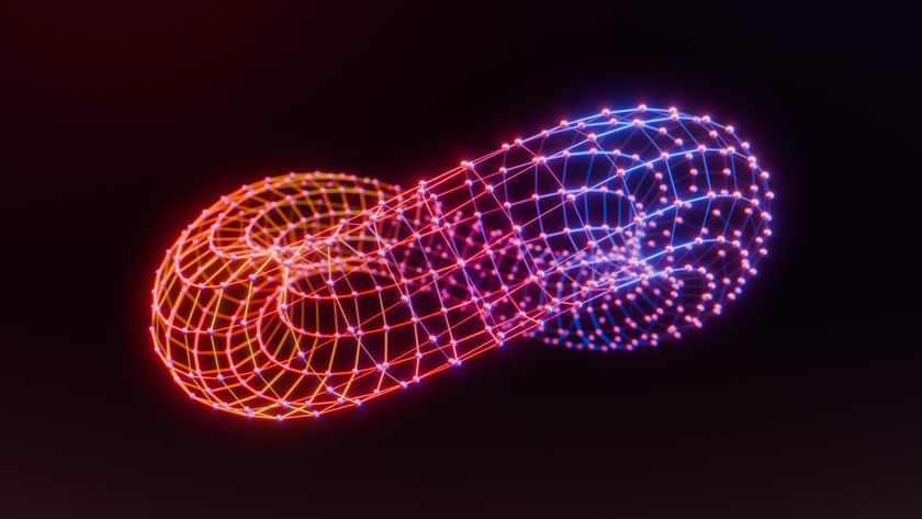 A glowing orange, red, blue, and purple torus formed from connected nodes to represent quantum computing and neuromorphic computing, set against a black background.