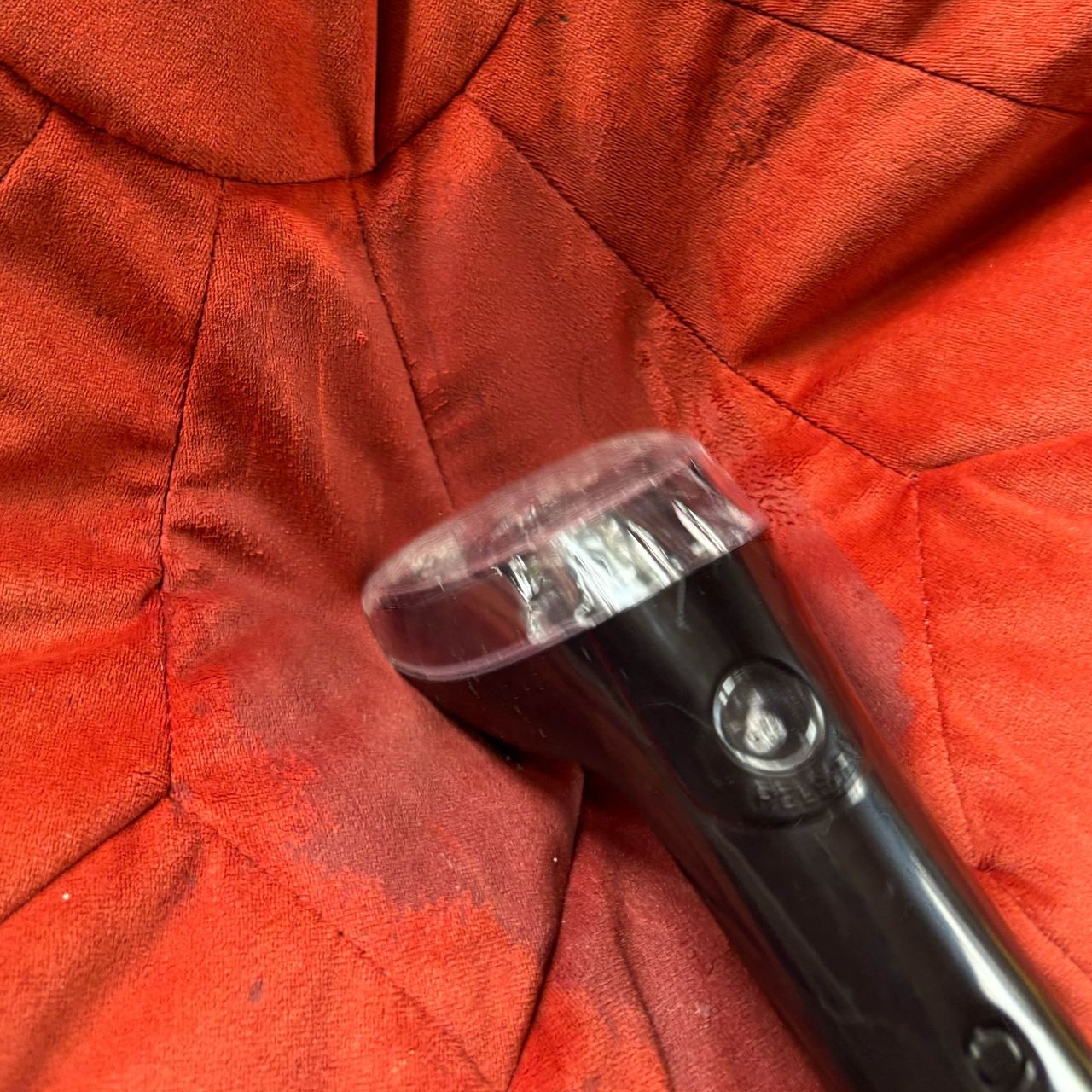 bissell proheat 2x revolution pet pro tough stain tool on red pouffe