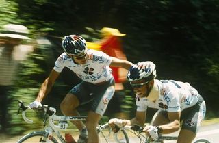 Baden Cooke drops back to give a word of encouragement to teammate Jimmy Casper as he struggles the day after his horrorific crash in the Tour de France.