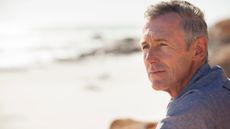 Close up of thoughtful mature man at the beach 