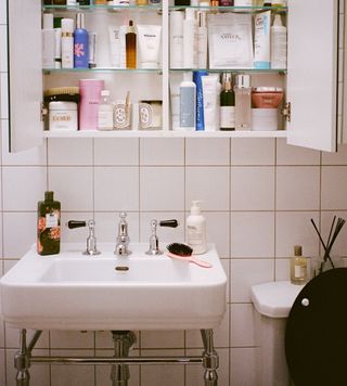 @emmahoareau bathroom cupboard full of beauty products