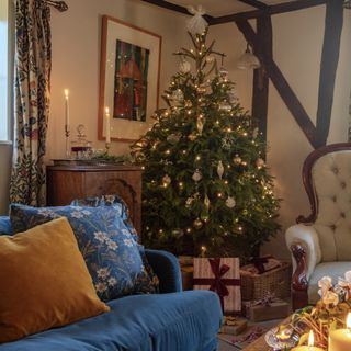grade ll listed suffolk cottage christmas tree and blue velvet sofa