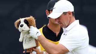 Rory McIlroy of Northern Ireland removes the Dog Driver Head Cover as they prepare to tee off on the 1st hole on Day Three of The 151st Open at Royal Liverpool Golf Club